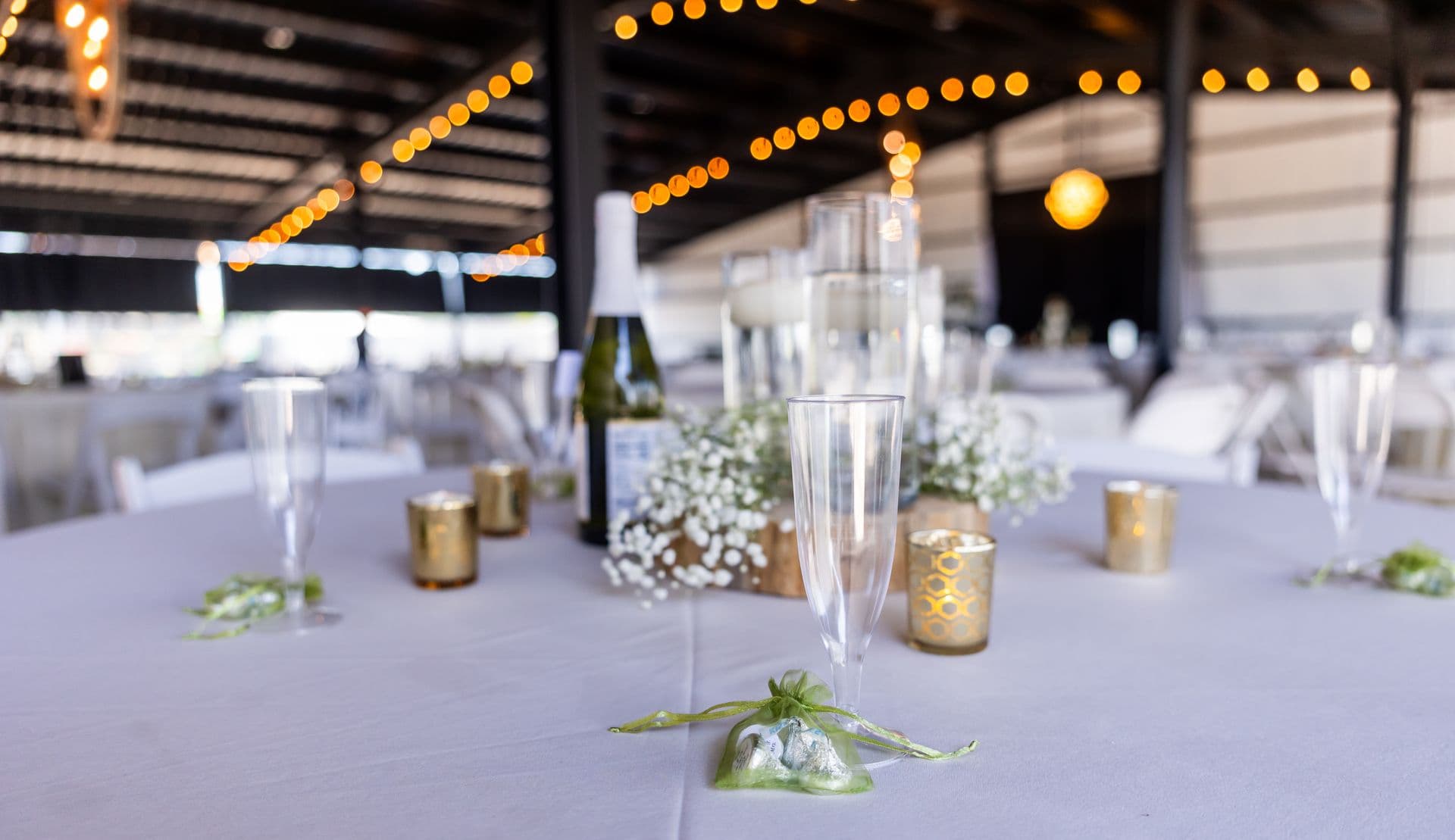 Elegant reception table styled with candlelight and soft floral accents