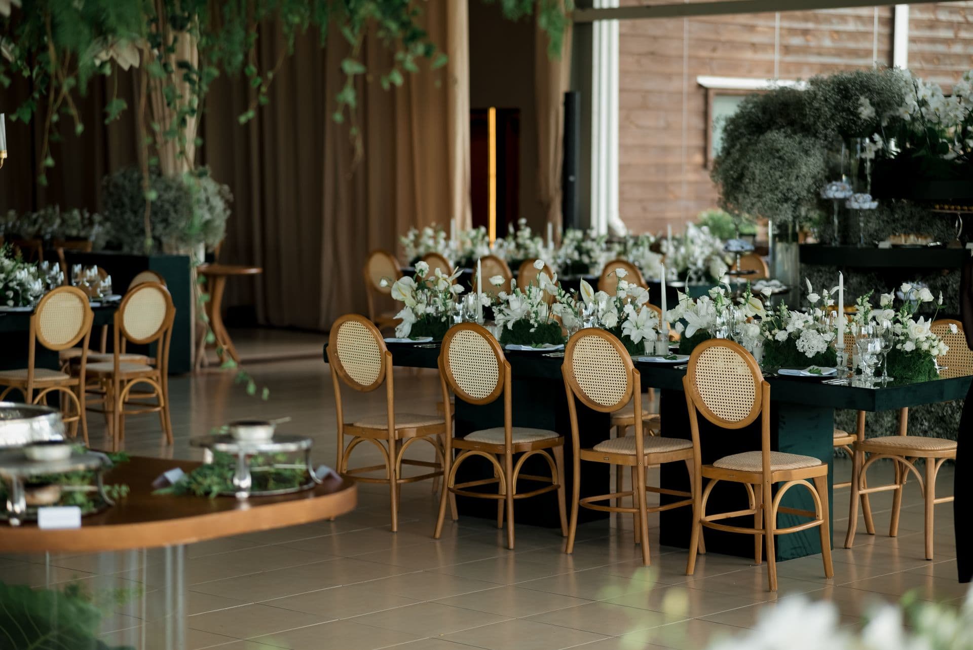 Elegant wedding reception with greenery, florals, and gold accents